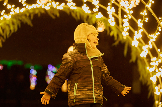 A child enjoying the the light tunnel at the Let It Glow - A Celebration of Light in Rennie Park.