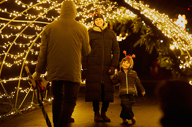 A family in the light tunnel at the Let It Glow - A Celebration of Light in Rennie Park.