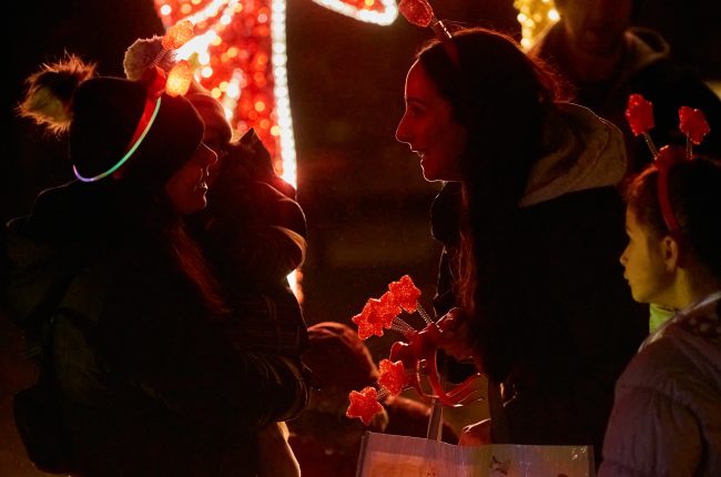 Opening night at the Let it Glow - A Celebration of Light festival features glow-in-the-dark giveaways.